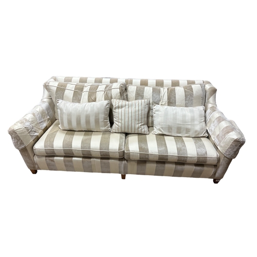 248 - A THREE SEATER SETTEE of rectangular outline with loose cushions on square tapering legs 200cm (w)