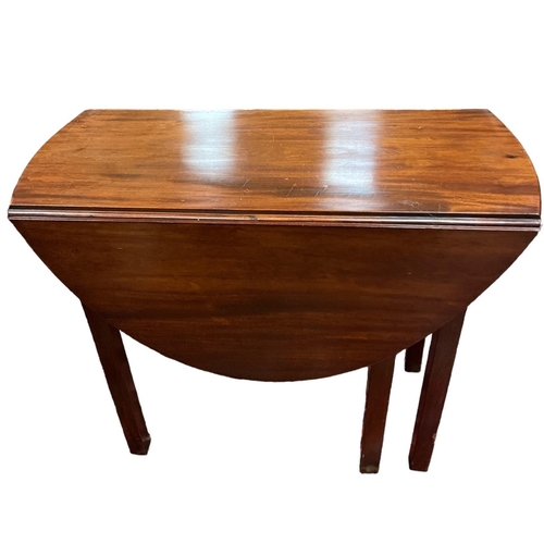 26 - A GEORGIAN MAHOGANY DROP LEAF TABLE the oval hinged top with frieze drawer on square moulded legs 73... 