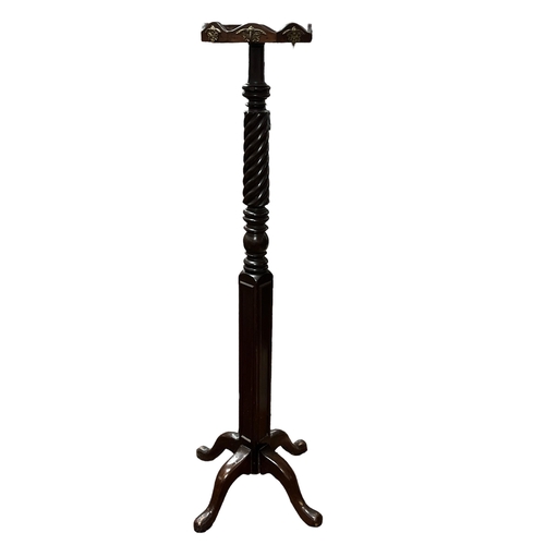 32 - A 19TH CENTURY MAHOGANY HALLSTAND with spiral twist and square column with brass hooks on tripod sup... 