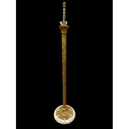 33 - A GILT BRASS FIVE LIGHT FLOOR STANDARD LAMP the embossed cylindrical column on a circular white vein... 