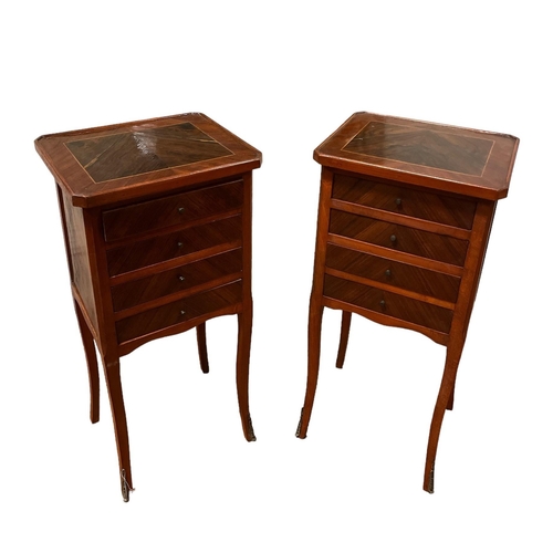 41 - A PAIR OF CONTINENTAL KINGWOOD CHESTS each of rectangular outline with four long drawers on slender ... 