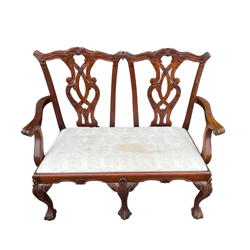 43 - A CHIPPENDALE STYLE MAHOGANY DOUBLE CHAIR BACK SETTEE with pierced vertical splats and upholstered d... 