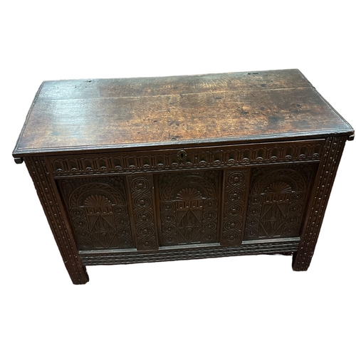 45 - A 19TH CENTURY CARVED OAK COFFER the hinged lid with carved panels and legs 73cm (h) x 114cm (w) x 5... 