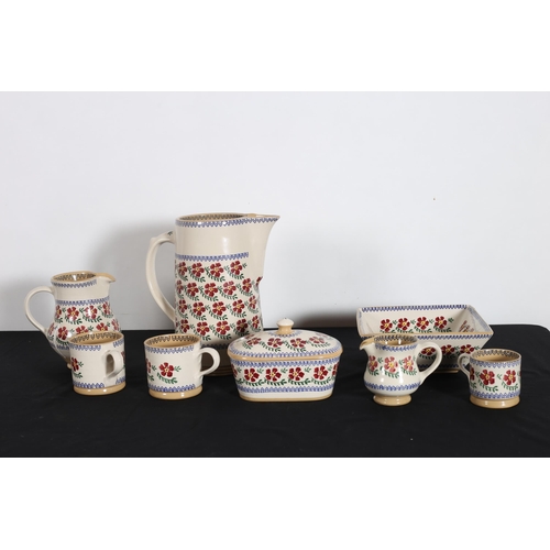 549 - NICHOLAS MOSS POTTERY Old Rose Pattern comprising three jugs, two large mugs, one small mug, a lidde... 