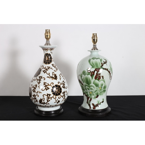 562 - TWO PORCELAIN TABLE LAMPS of bulbous and baluster form on hardwood stands 47cm (h)