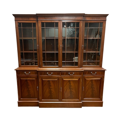 59 - A GEORGIAN STYLE MAHOGANY BREAKFRONT LIBRARY BOOKCASE with astragal glazed doors and adjustable shel... 