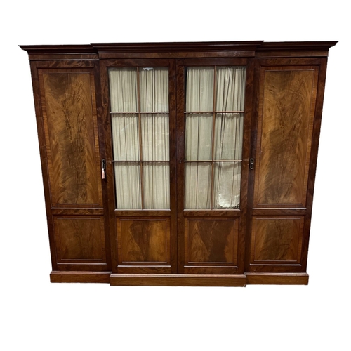 62 - A LATE 19TH CENTURY MAHOGANY FOUR DOOR BREAKFRONT WARDROBE the moulded cornice above a pair of astra... 