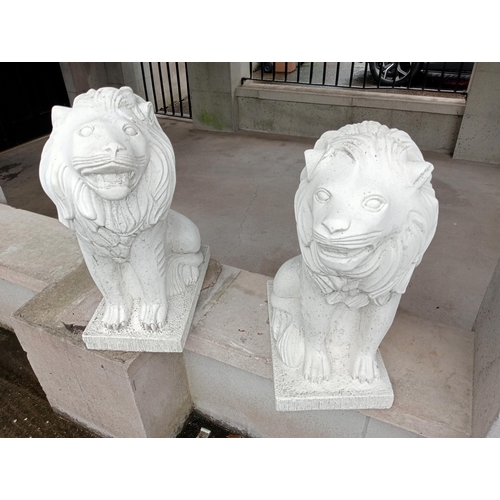 651 - A PAIR OF COMPOSITION STONE FIGURES each modelled as a lion shown seated on a rectangular base 70cm ... 