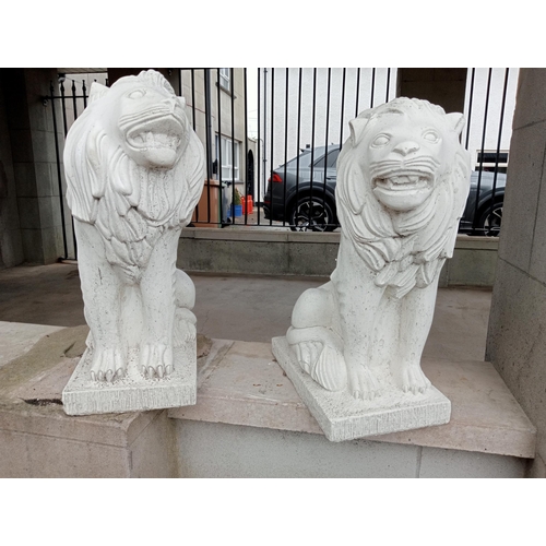 651 - A PAIR OF COMPOSITION STONE FIGURES each modelled as a lion shown seated on a rectangular base 70cm ... 