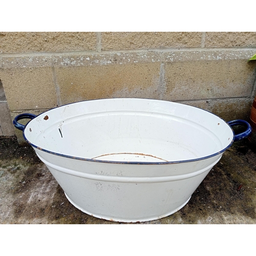 652 - A VINTAGE ENAMEL BATH of oval outline with carrying handles 24cm (h) x 74cm (w) x 45cm (d)