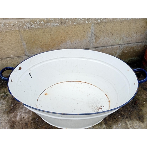 652 - A VINTAGE ENAMEL BATH of oval outline with carrying handles 24cm (h) x 74cm (w) x 45cm (d)