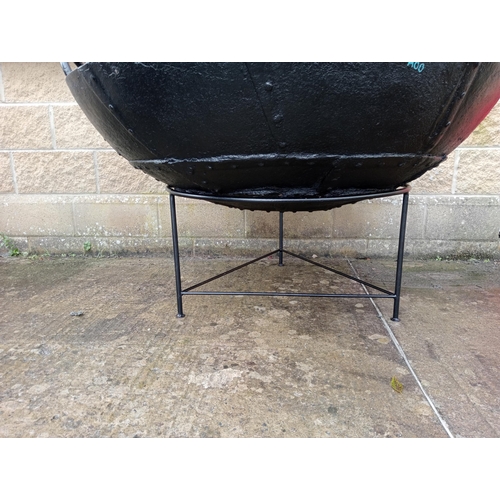 658 - A LARGE BLACK METAL FIRE PIT of dish form raised on a tubular base 86cm (h) x 130cm (d)