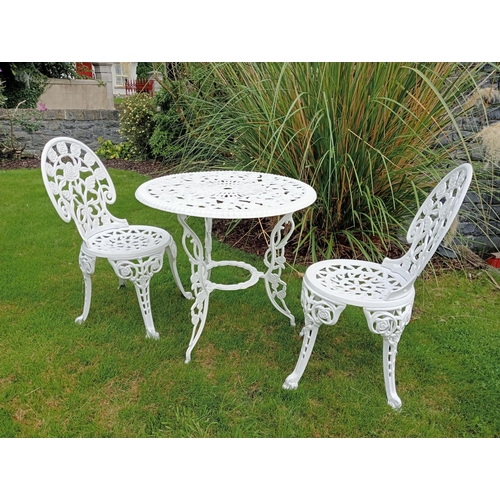 664 - A THREE PIECE CAST ALUMINIUM PATIO SUITE comprising a circular pierced top table on splayed legs tog... 