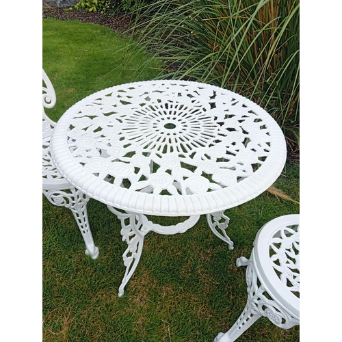 664 - A THREE PIECE CAST ALUMINIUM PATIO SUITE comprising a circular pierced top table on splayed legs tog... 