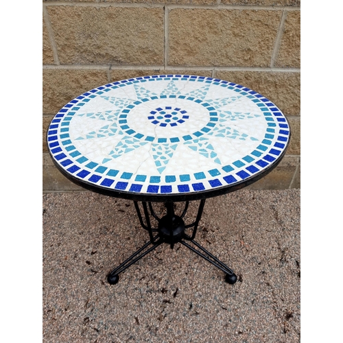 667 - A WROUGHT IRON AND MOSAIC GARDEN TABLE of circular form 74cm (h) x 60cm (d)