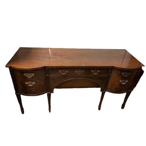 67 - A GEORGIAN STYLE MAHOGANY SIDEBOARD of rectangular bowed outline with two frieze drawers flanked by ... 