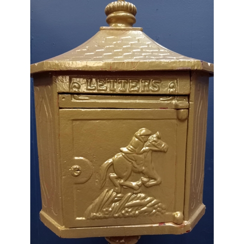 670 - A CAST IRON FREESTANDING POSTBOX of rectangular form with canted angles on hardwood base 110cm (h) x... 