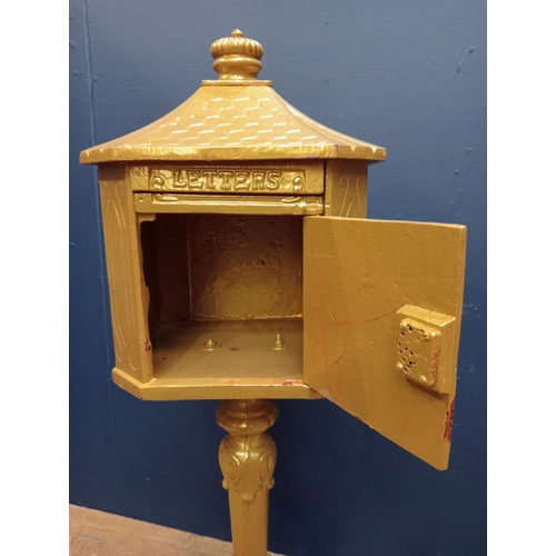 670 - A CAST IRON FREESTANDING POSTBOX of rectangular form with canted angles on hardwood base 110cm (h) x... 