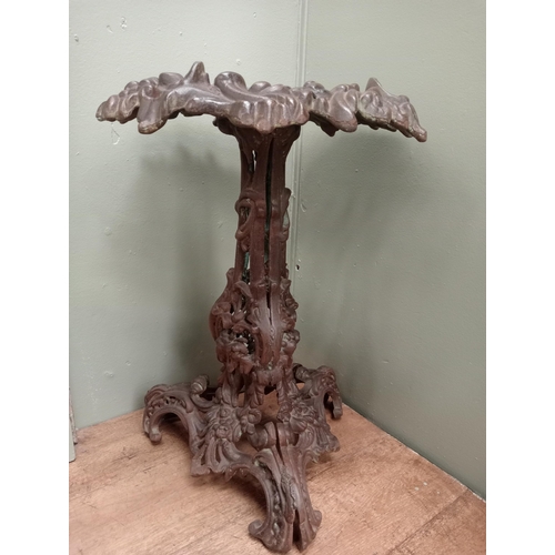 681 - A CAST IRON TABLE with foliate decoration on tripod support with scroll toes and tiled inset 66cm (h... 