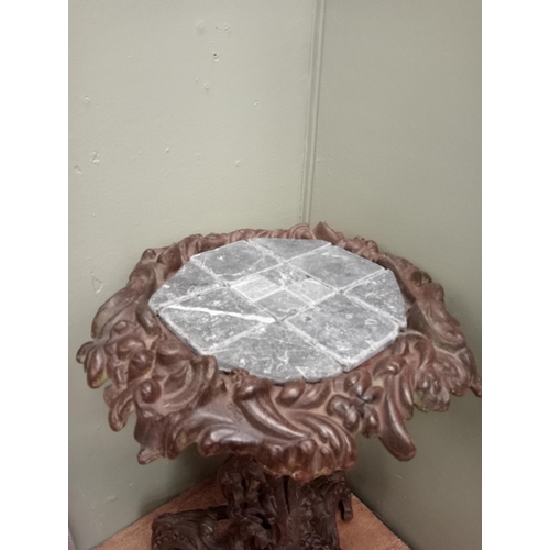 681 - A CAST IRON TABLE with foliate decoration on tripod support with scroll toes and tiled inset 66cm (h... 