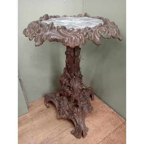 681 - A CAST IRON TABLE with foliate decoration on tripod support with scroll toes and tiled inset 66cm (h... 