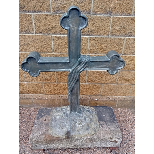 688 - A BRONZE CROSS on a naturalistic foot with sandstone plinth 150cm (h) x 100cm (w) x 50cm (d)