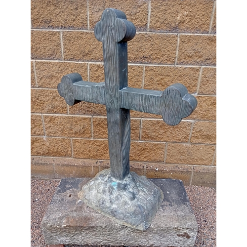 688 - A BRONZE CROSS on a naturalistic foot with sandstone plinth 150cm (h) x 100cm (w) x 50cm (d)