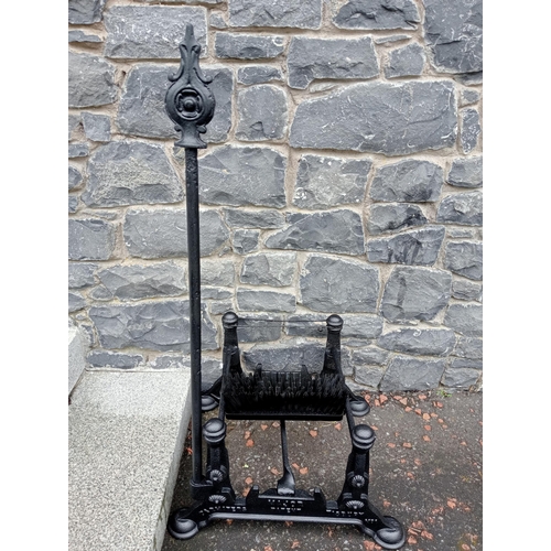 689 - A CAST IRON FOOT SCRAPE with brush and scrape on pad feet 97cm (h) x 54cm (w) x 44cm (d)