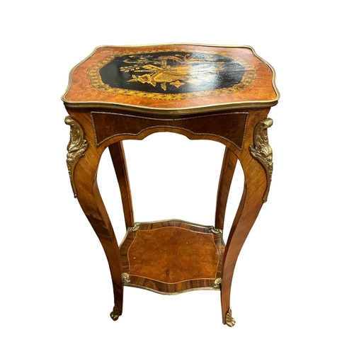 79 - A CONTINENTAL KINGWOOD AND GILT BRASS MOUNTED TABLE of serpentine outline inlaid with musical trophi... 