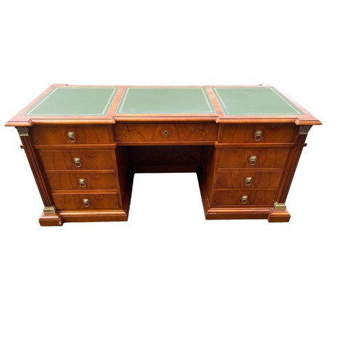 556 - A WALNUT EMPIRE DESIGN MAHOGANY PEDESTAL DESK with three frieze drawers raised on twin three drawers... 