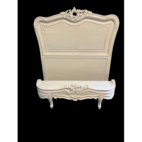 538 - A CONTINENTAL WHITE PAINTED CARVED WOOD SINGLE BED with a flowerhead and foliate cresting above a sh... 