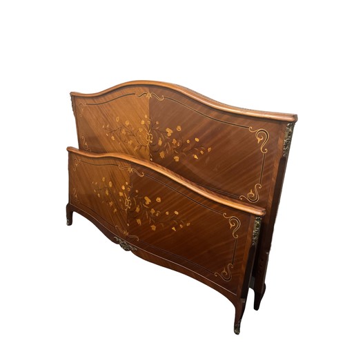 603 - A CONTINENTAL KINGWOOD MARQUETRY AND GILT BRASS MOUNTED BED the rectangular arched headboard with co... 