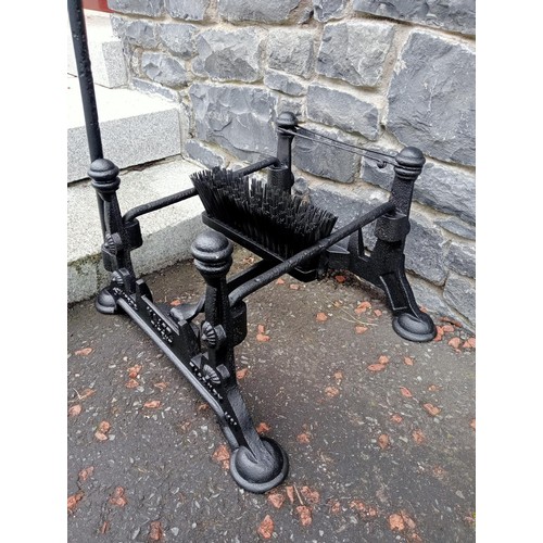 689 - A CAST IRON FOOT SCRAPE with brush and scrape on pad feet 97cm (h) x 54cm (w) x 44cm (d)