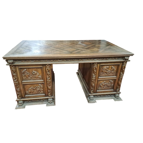 713 - A JACOBEAN STYLE MAHOGANY PEDESTAL DESK of rectangular outline the shaped top above a pair of carved... 