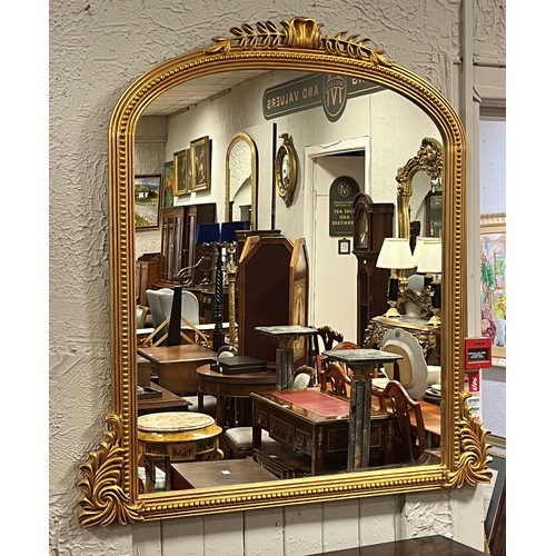 50 - A VICTORIAN STYLE CARVED GILTWOOD OVERMANTEL MIRROR the rectangular arched plate within a beadwork f... 