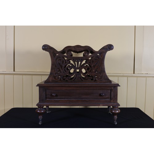 29 - A HARDWOOD FOUR DIVISION CANTERBURY with pierced fretwork slats with frieze drawer on bun feet 57cm ... 