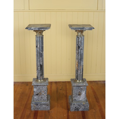 38 - A PAIR OF CONTINENTAL VEINED MARBLE AND GILT BRASS MOUNTED COLUMNS each with a square moulded top ab... 