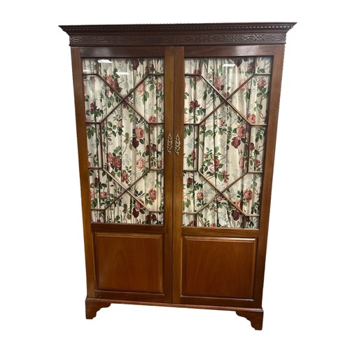 170 - A LATE 19TH CENTURY MAHOGANY TWO DOOR WARDROBE with astragal glazed doors containing hanging rail on... 