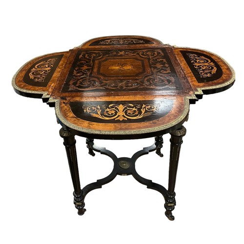 179 - A CONTINENTAL KINGWOOD WALNUT AND EBONISED DROP LEAF TABLE the rectangular top with four hinged leav... 