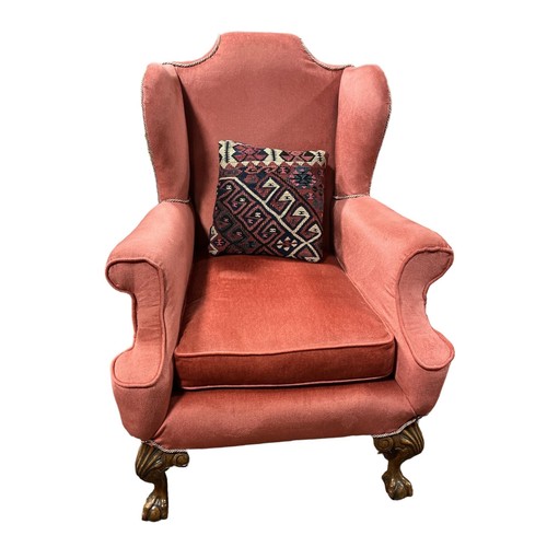 217 - A GEORGIAN STYLE MAHOGANY AND UPHOLSTERED WING CHAIR with scroll over arms and loose cushion on cabr... 