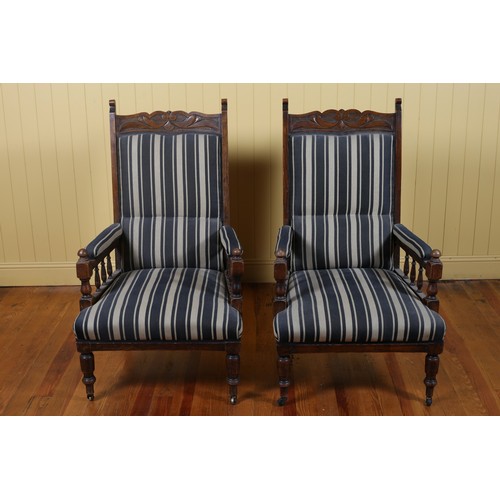 259 - A PAIR OF EDWARDIAN CARVED OAK ARMCHAIRS with upholstered back and seats on baluster legs