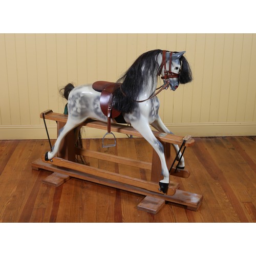 260 - A VINTAGE ROCKING HORSE on pine stand with leather saddle and bridle bears label 'Haddon Rocking Hor... 