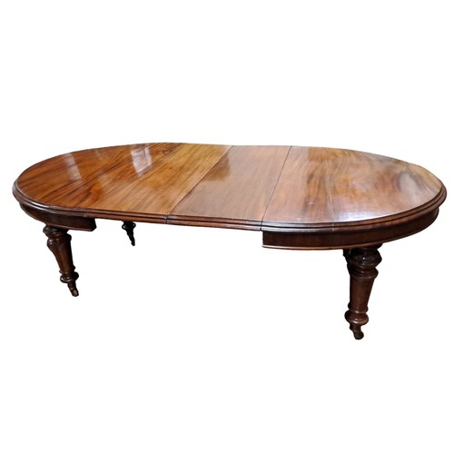 269 - A 19TH CENTURY MAHOGANY TELESCOPIC DINING TABLE of rectangular outline with rounded ends and two loo... 