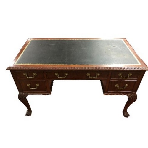 270 - A VINTAGE MAHOGANY DESK of rectangular outline the shaped top with tooled leather inset, two short a... 