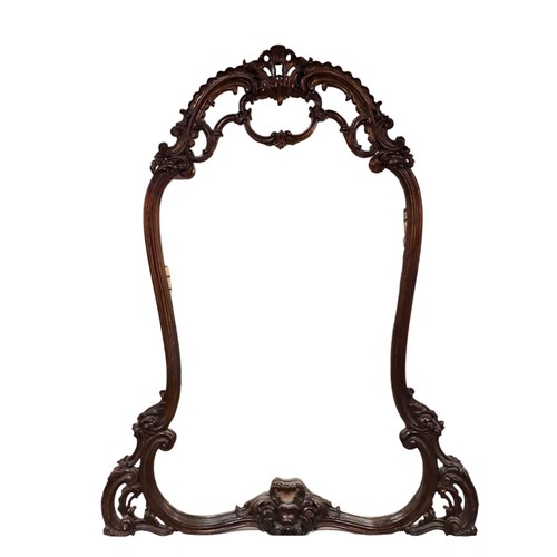 49 - A STAINED WOOD CARVED FRAME MIRROR the shaped plate within a C-scroll and foliate carved frame with ... 