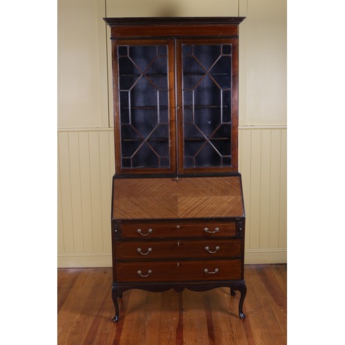 255 - A VINTAGE MAHOGANY TWO DOOR BOOKCASE with astragal glazed doors and adjustable shelves the hinged wr... 