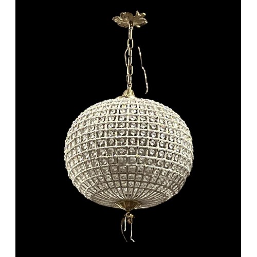 180 - A CONTINENTAL GILT BRASS AND CUT GLASS CENTRE LIGHT of bulbous form inset with faceted pendants with... 