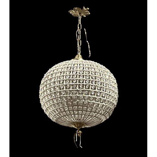 182 - A CONTINENTAL GILT BRASS AND CUT GLASS CENTRE LIGHT of bulbous form inset with faceted pendants with... 