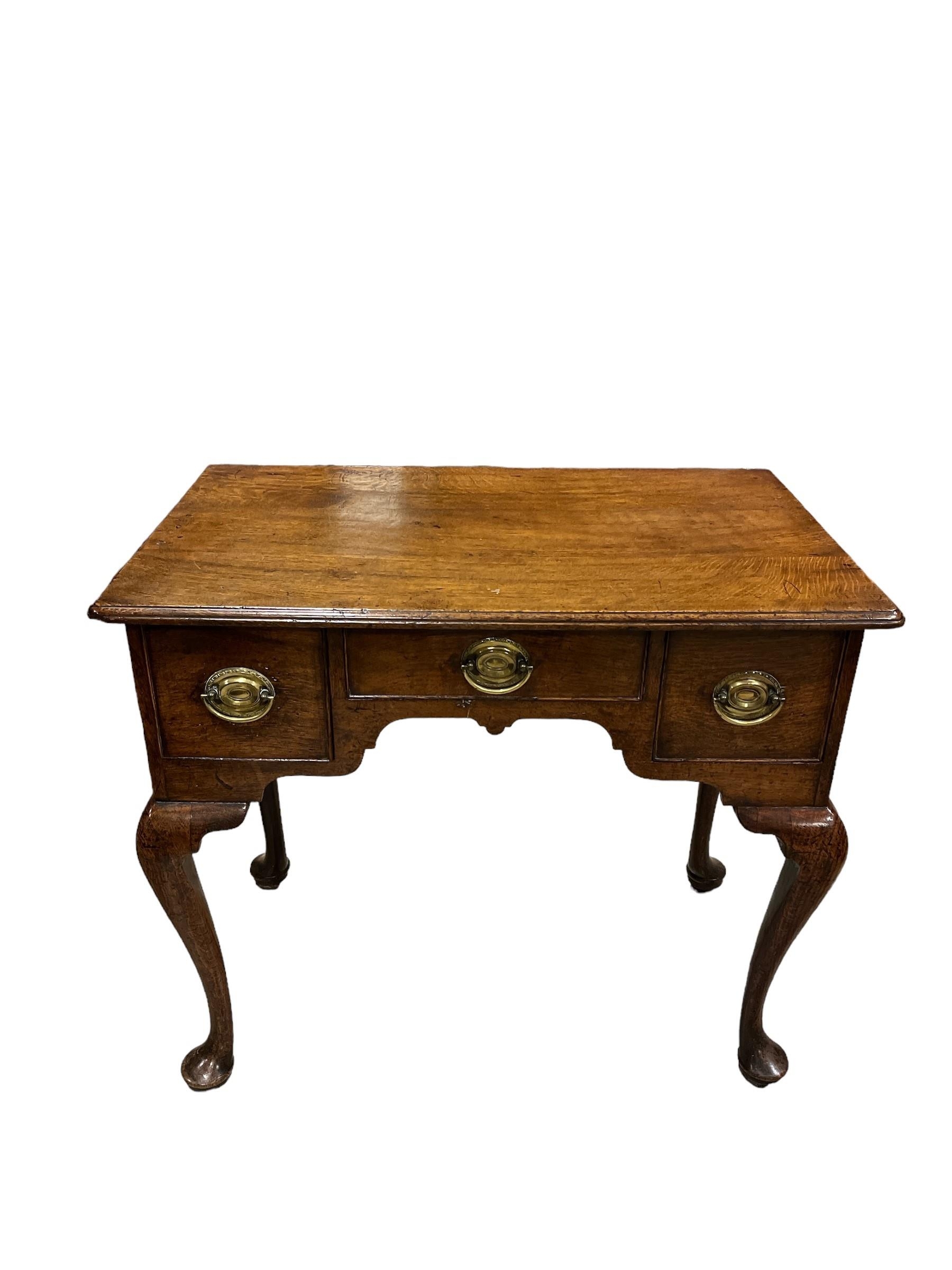 A 19TH CENTURY OAK LOWBOY with three frieze drawers on cabriole legs with pad feet 70cm (h) x 78cm