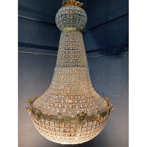 498 - A CONTINENTAL GILT BRASS AND CUT GLASS BASKET CENTRE LIGHT with cascading pendant drops the circlet ... 